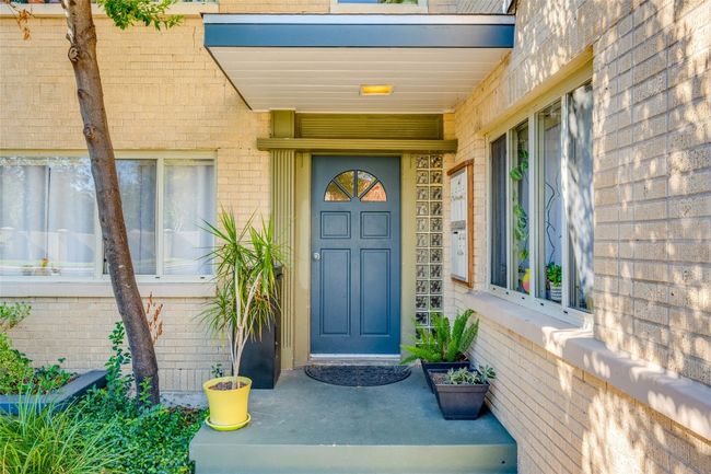 Doorway to property with brick siding and covered porch | Image 7