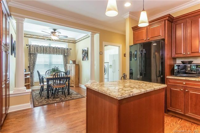Architectural columns flank the casual dining area. Just beyond this area, you will find a laundry room. | Image 9