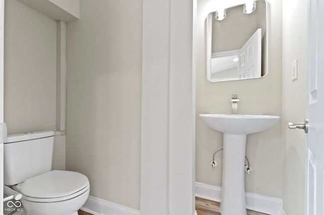 half bath featuring baseboards and toilet | Image 24