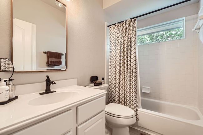 Bathroom featuring vanity and shower / bath combo | Image 18