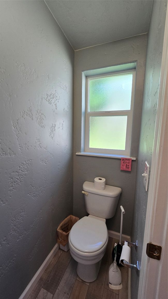 Bathroom with wood finished floors, toilet, and baseboards | Image 26