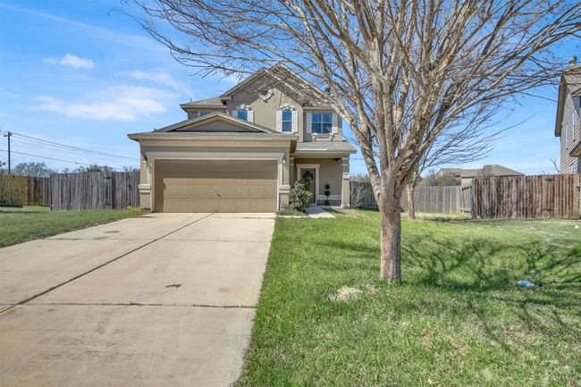 View of front of home with a garage, concrete driveway, fence, a front lawn, and stucco siding | Image 4
