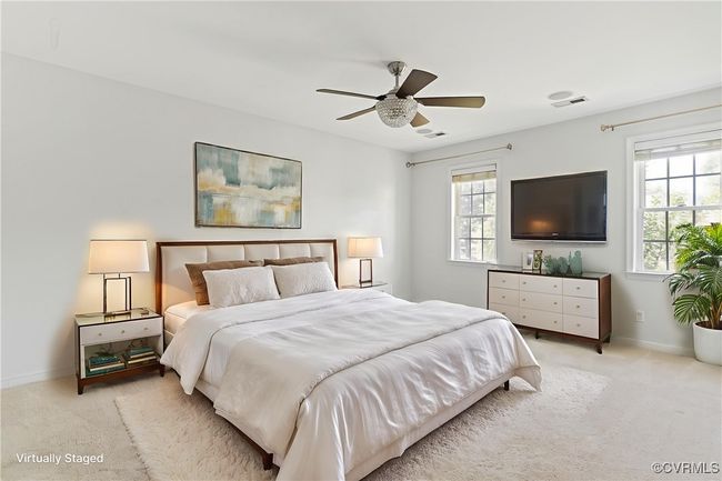 Carpeted bedroom with multiple windows and ceiling fan | Image 16