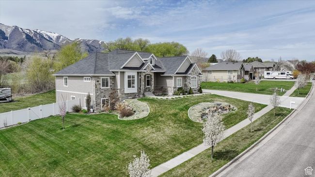 View of front of house featuring a gate, a front lawn, fence, and stone siding | Image 12