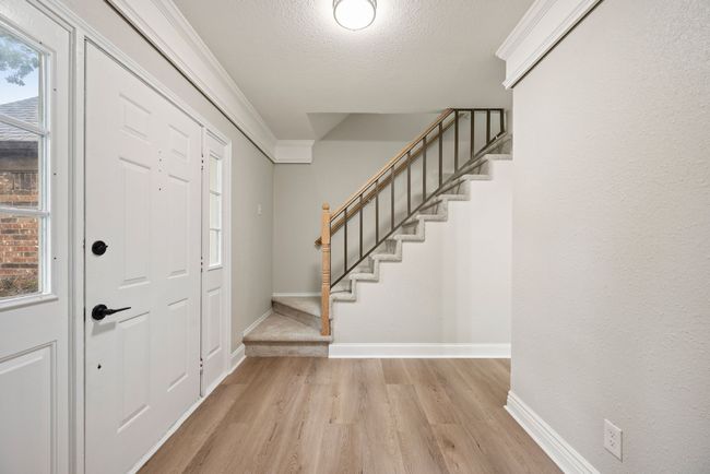The staircase has a simple, elegant railing. | Image 6
