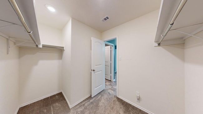 Spacious closet featuring carpet flooring and visible vents | Image 28