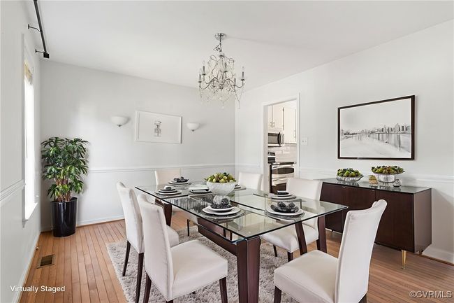 Dining space with a chandelier and light wood-style floors | Image 4