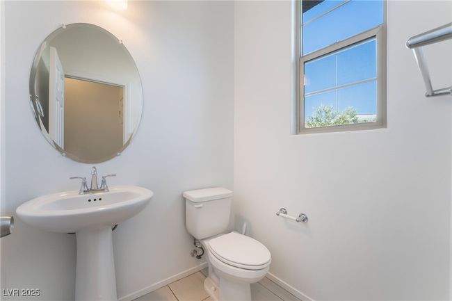 Downstairs Half bathroom featuring toilet and tile patterned flooring | Image 18
