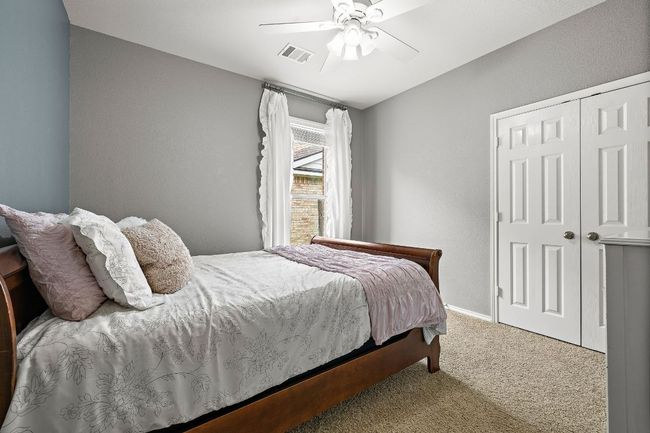 Bedroom featuring carpet flooring, a closet, ceiling fan, and baseboards | Image 24