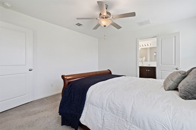 Bedroom featuring carpet, connected bathroom, and a ceiling fan | Image 17