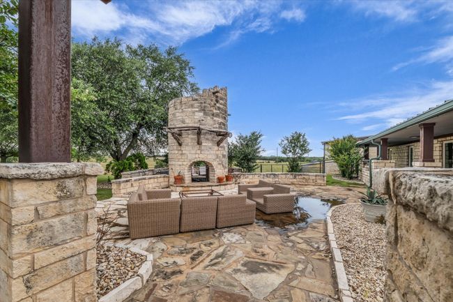 View of patio with an outdoor living space with a fireplace | Image 5