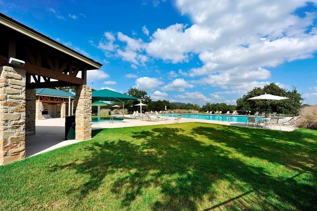 Grassy are around community pool | Image 36