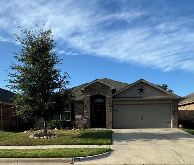 View of front facade featuring a garage and a front yard | Image 1