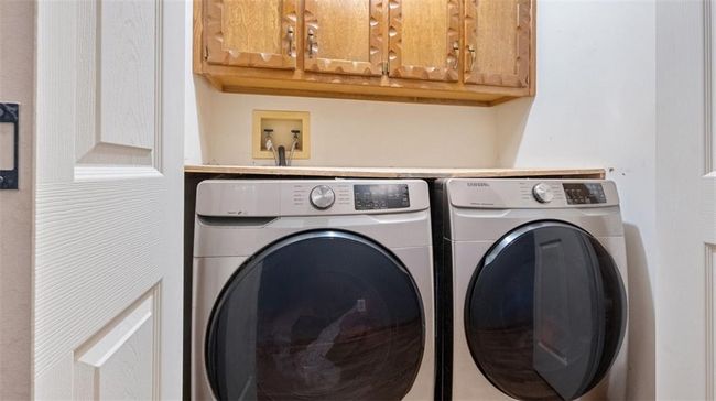 Laundry area with washing machine and dryer and cabinet space | Image 17