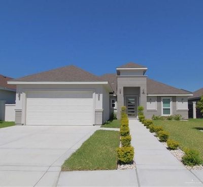 View of front of house featuring a garage and a front lawn | Image 1