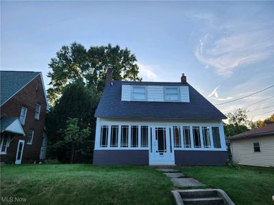 View of front of house featuring a lawn and a sunroom | Image 1