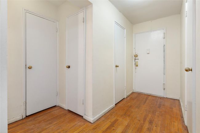 Hallway with light wood-style flooring | Image 9