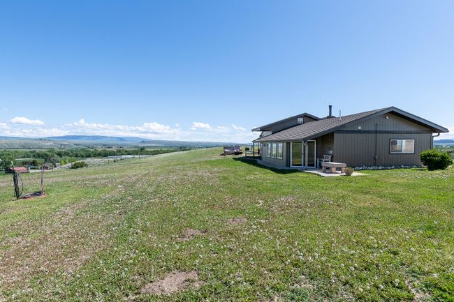 View of green lawn with a patio area | Image 8