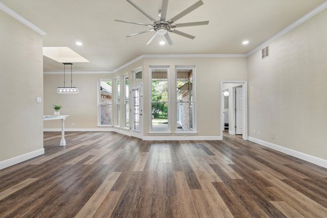 The living room looks out over the back patio and has plenty of space being the center of the house! | Image 7