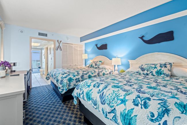Carpeted bedroom featuring a closet and tile patterned floors | Image 6