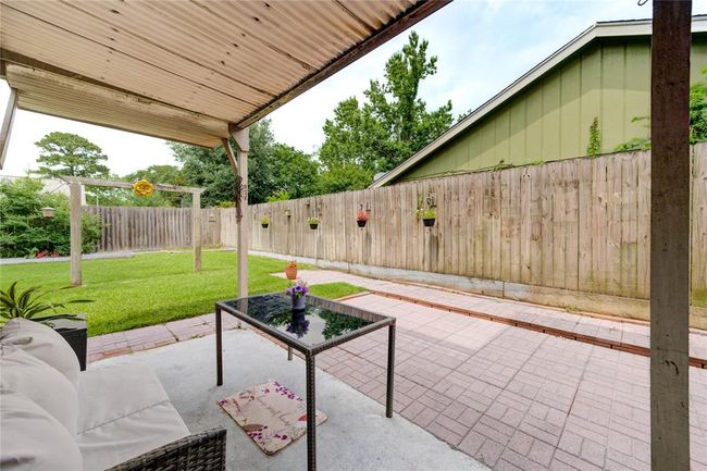 This inviting outdoor space blends natural beauty and comfort—perfect for sipping coffee, reading a book, or enjoying the breeze surrounded by greenery | Image 9
