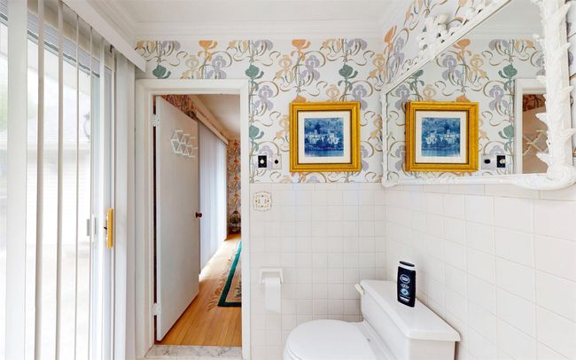 Bathroom featuring ornamental molding, wallpapered walls, toilet, and tile walls | Image 37