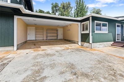 Carport with separate entries to each side of the house. 2 full size truck can fit | Image 2