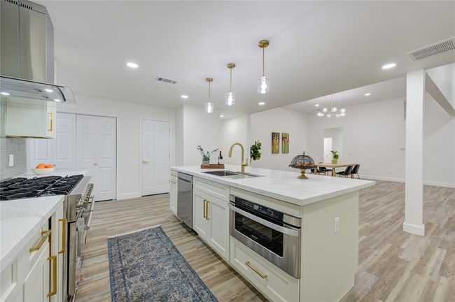 A 6-burner Professional Series Gas Range is the star of the kitchen, perfect for the home chef. The custom cabinetry offers plenty of storage, while new lighting fixtures brighten the entire space. | Image 14
