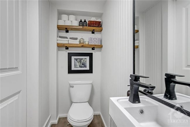 Well Appointed powder room on main level tucked away under the stairs | Image 14