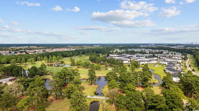 View of property location featuring a large body of water, a local golf course, and nearby suburban area | Image 29