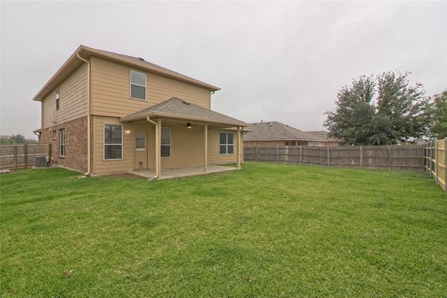 Rear view of house with a patio area, a fenced backyard, and a ceiling fan | Image 32