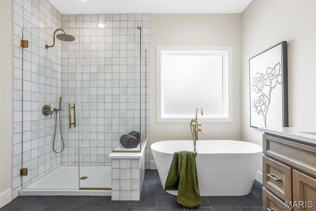 Primary en suite with custom tile shower and relaxing soaking tub! | Image 37
