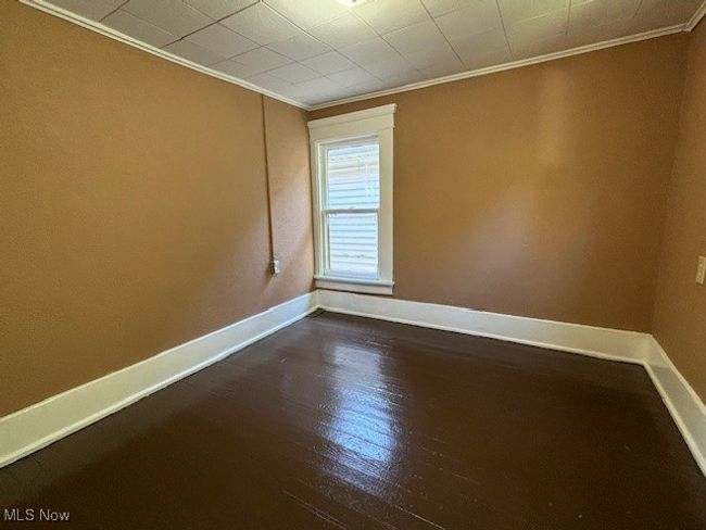 Unfurnished room with ornamental molding and dark hardwood / wood-style flooring | Image 15