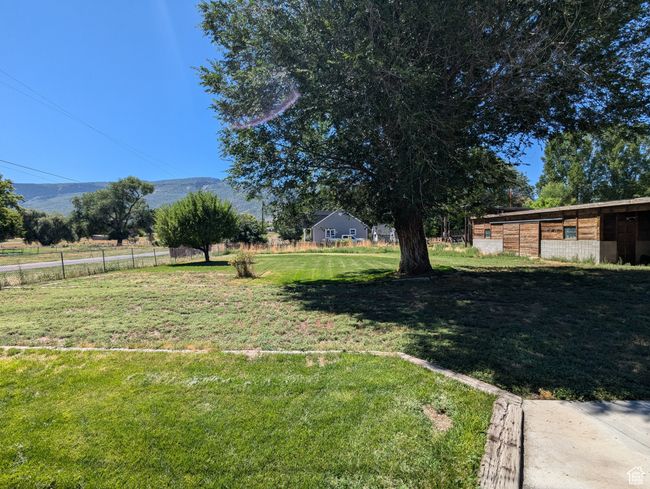 View of yard with an outbuilding and a mountain view | Image 30