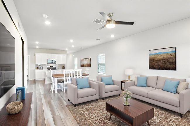 A great place to cozy up and watch a movie. Virtually staged to show one variation of furnishing arrangement | Image 13