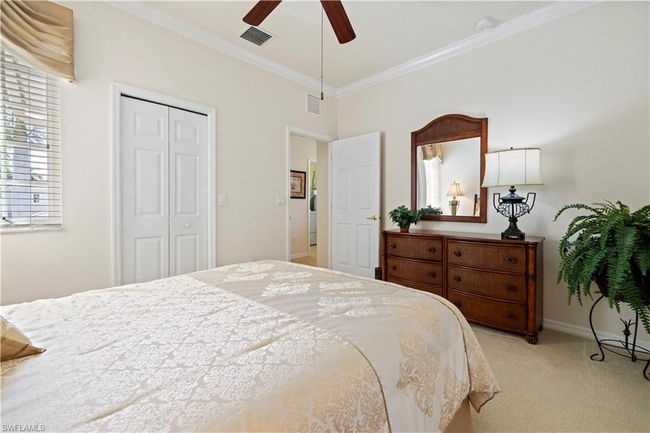 Bedroom #2 with crown molding, carpet, baseboards, visible vents, and a closet | Image 9