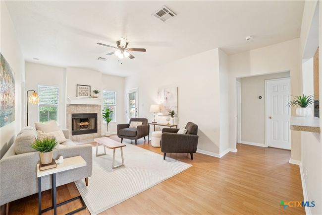 Another view of the Living Room with Center Fireplace. Doorway to the right leads to 2 secondary bedrooms. | Image 4
