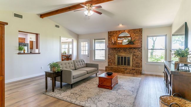 Living room featuring a wealth of natural light, visible vents, and ceiling fan | Image 16
