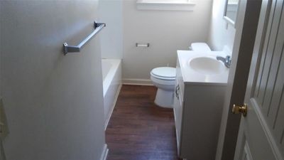 Full bathroom featuring plus walk in shower, toilet, vanity, and wood-type flooring | Image 3