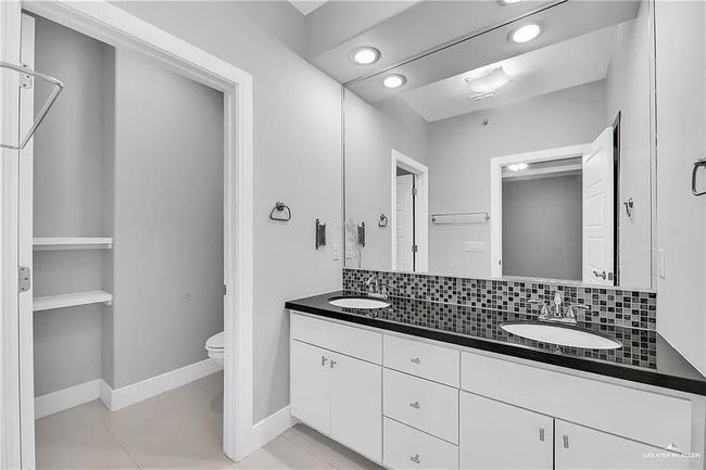 Full bathroom with double vanity, backsplash, and recessed lighting | Image 15