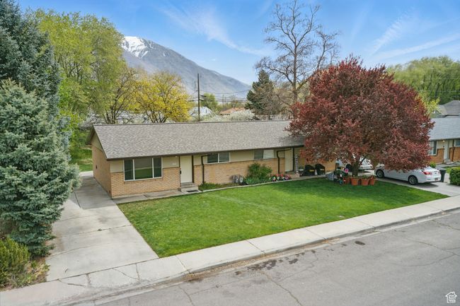 Single story home with driveway, brick siding, roof with shingles, a front yard, and a mountain view | Image 32
