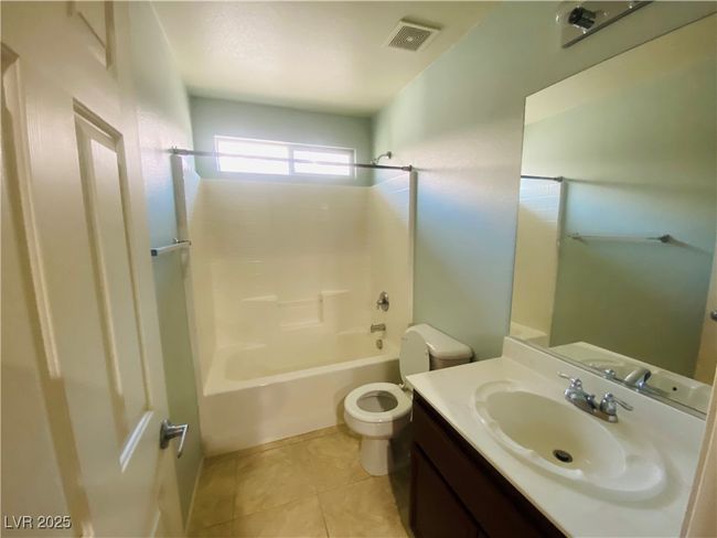 Full bath with tile patterned flooring, visible vents, shower / washtub combination, toilet, and vanity | Image 20