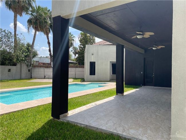 View of pool featuring a ceiling fan, a fenced backyard, and a patio area | Image 35