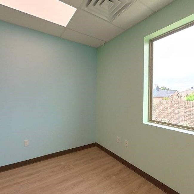 Empty room featuring baseboards, a paneled ceiling, and light wood-style flooring | Image 5