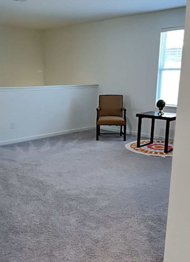 Living area with carpet flooring and baseboards | Image 31