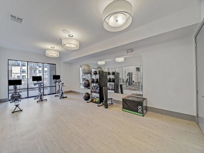 Workout area featuring wood finished floors, visible vents, and baseboards | Image 34