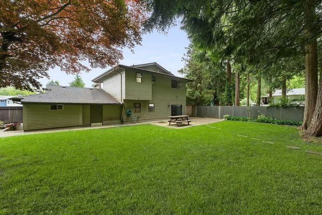 Rear view of house featuring a patio, central air condition unit, a yard, and fence | Image 16