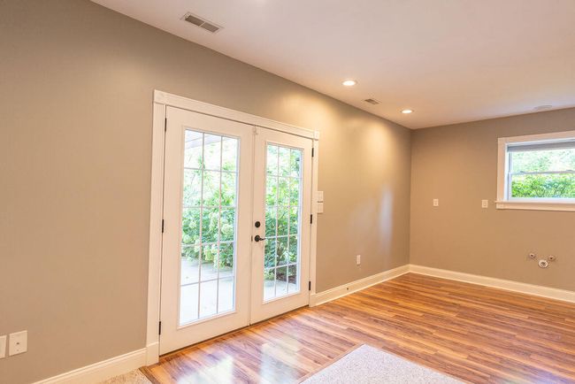 French doors leading to concrete patio. | Image 68