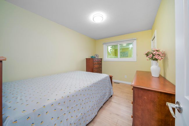 Bedroom featuring baseboards, visible vents, and light wood finished floors | Image 14