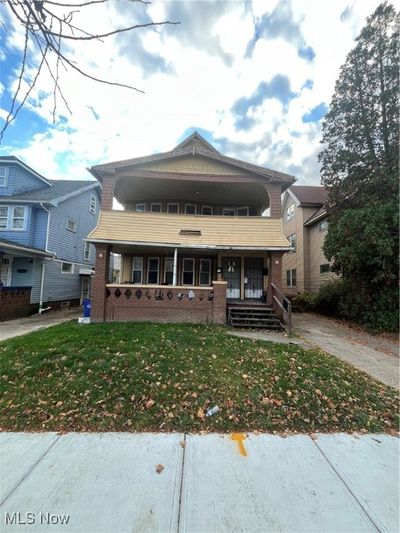 View of front of home featuring a front lawn and covered porch | Image 1